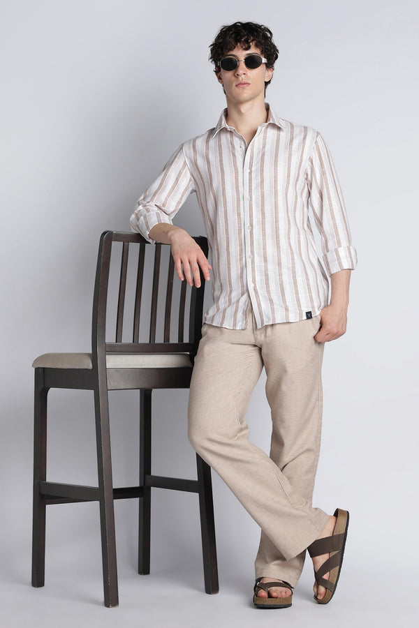 Editorial look with IVYN mushroom taupe trousers and a striped shirt