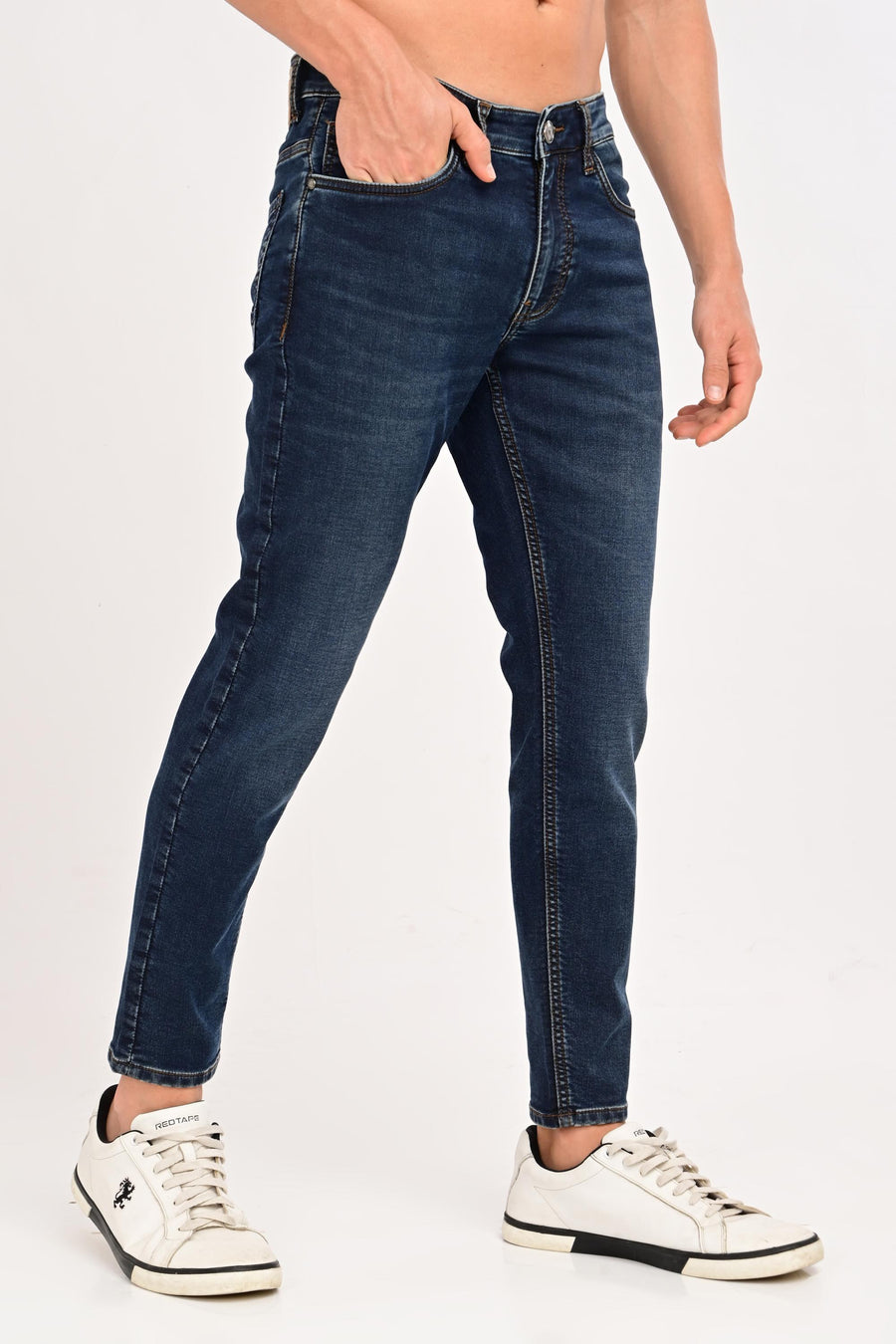 Angled front view of IVYN Arden Deep Indigo Wash ankle-fit jeans