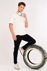 Model wearing IVYN Arden Jet Black ankle-fit jeans with a white T-shirt