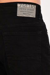 Rear pocket and IVYN Jeans waist label detail on Jet Black jeans