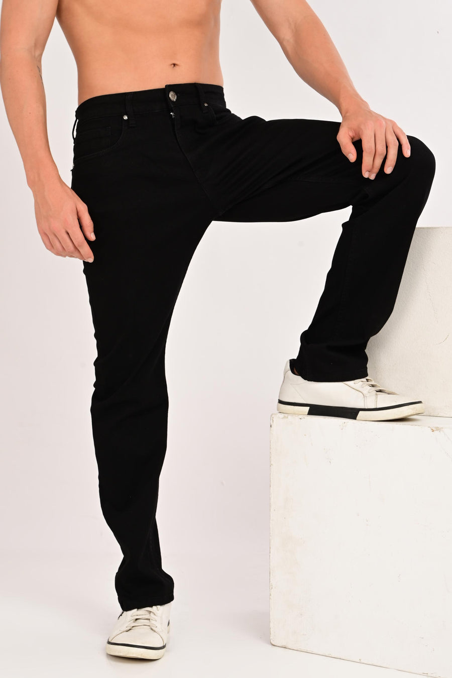 Raised-leg view showing the fit and movement of IVYN Camden Jet Black jeans