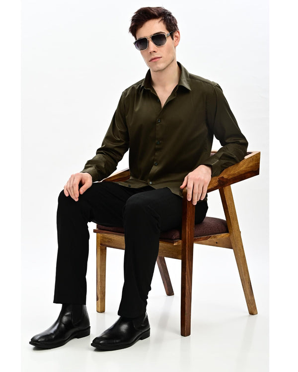 Military olive satin slim fit shirt with black trousers and leather shoes – full length seated