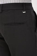 Rear welt pocket and IVYN metal detail on Charcoal formal trousers