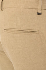 Rear welt pocket and IVYN metal detail on Desert Sand melange trousers