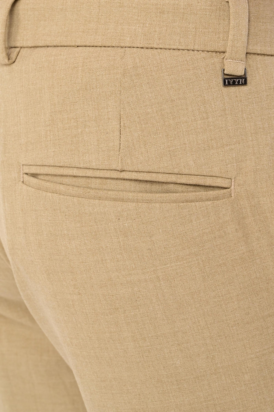 Rear welt pocket and IVYN metal detail on Desert Sand melange trousers