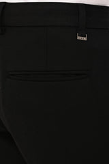 Rear welt pocket and IVYN metal detail on Jet Black formal trousers