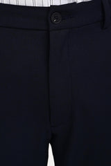 Waistband, button and concealed fly detail of IVYN Midnight Navy trousers
