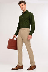 Model wearing IVYN Regent Mushroom Taupe formal trousers with a green shirt