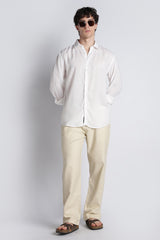 Standing editorial look featuring IVYN soft cream straight-fit trousers