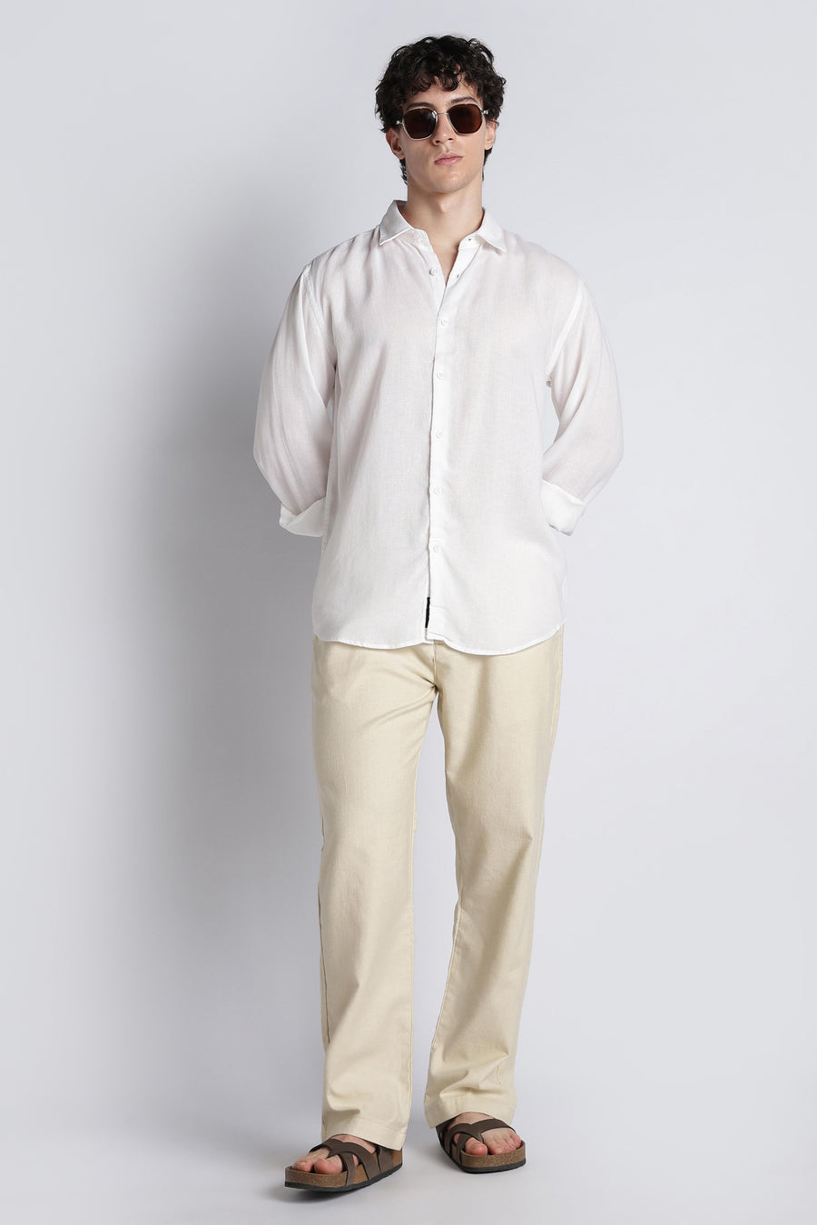 Standing editorial look featuring IVYN soft cream straight-fit trousers